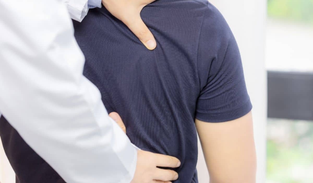 Chiropractor examining a man's back