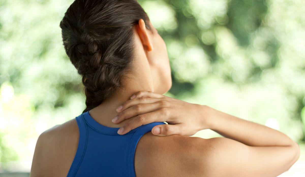 Woman holding the back of her neck