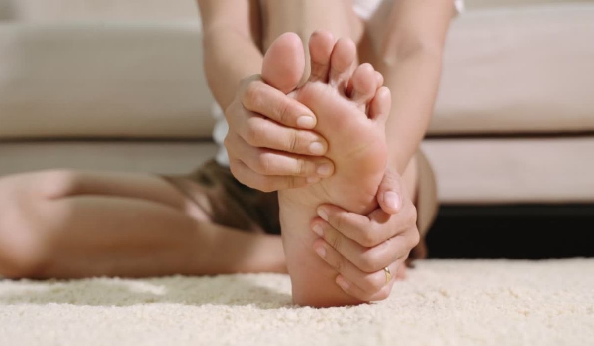 Person rubbing the sole of a numb foot