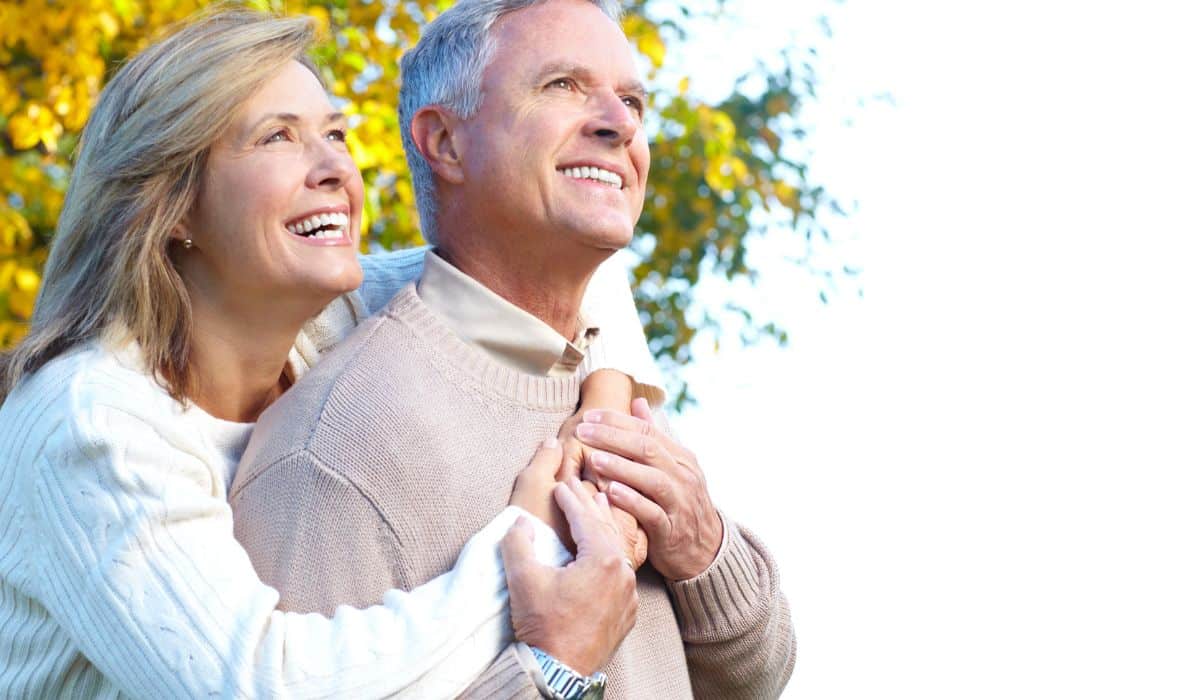 Smiling older couple enjoying a walk outdoors