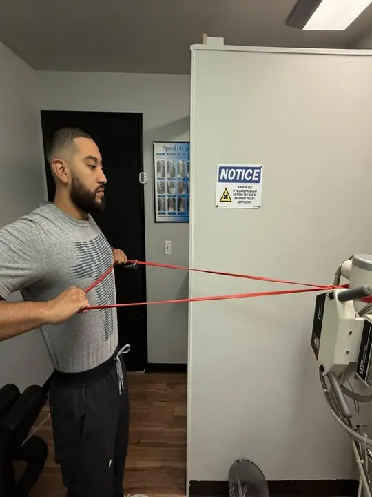 Band Rows: End: band pulled to the chest, elbows back
