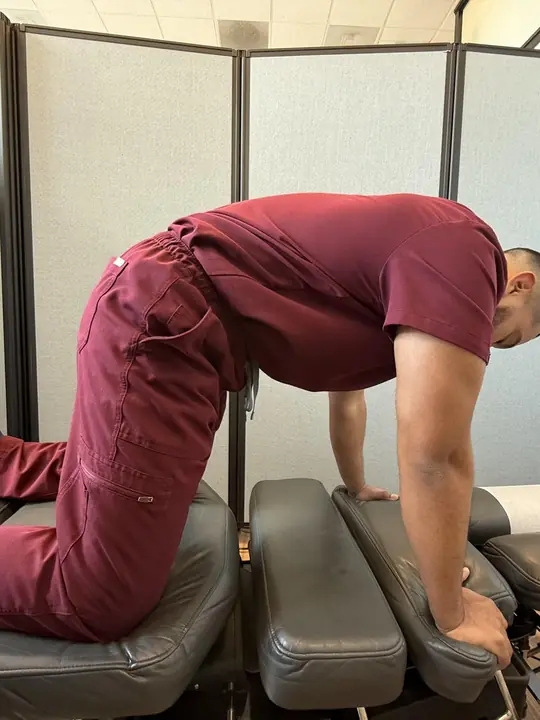 Cat-Cow: Cat: spine rounds up, chin tucked