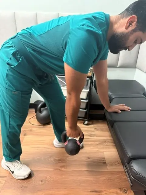 Pendulum Exercise: Lean on a table and let the arm hang and swing gently