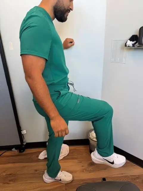 Standing Hip Circles: Knee lifts forward