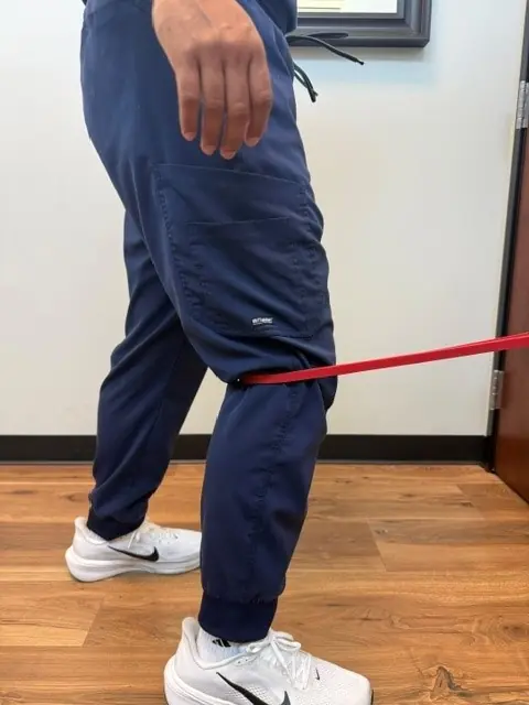 Terminal Knee Extension with Band: Start: knee slightly bent, band behind the knee