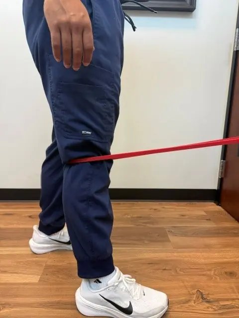 Terminal Knee Extension with Band: Knee pressed straight against the band