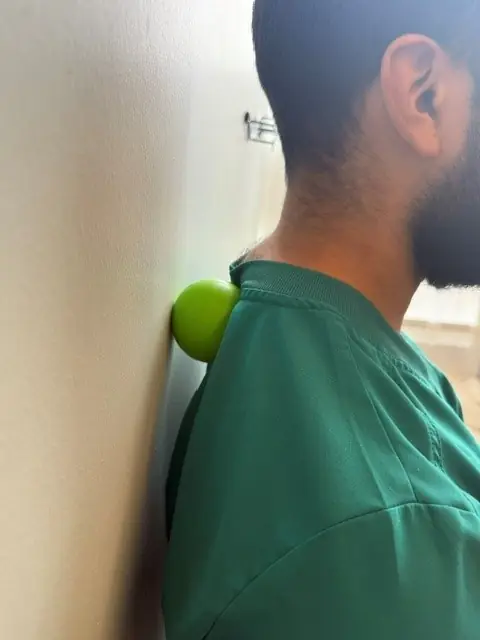 Upper Trap and Levator Ball Release: Ball between the upper shoulder and the wall
