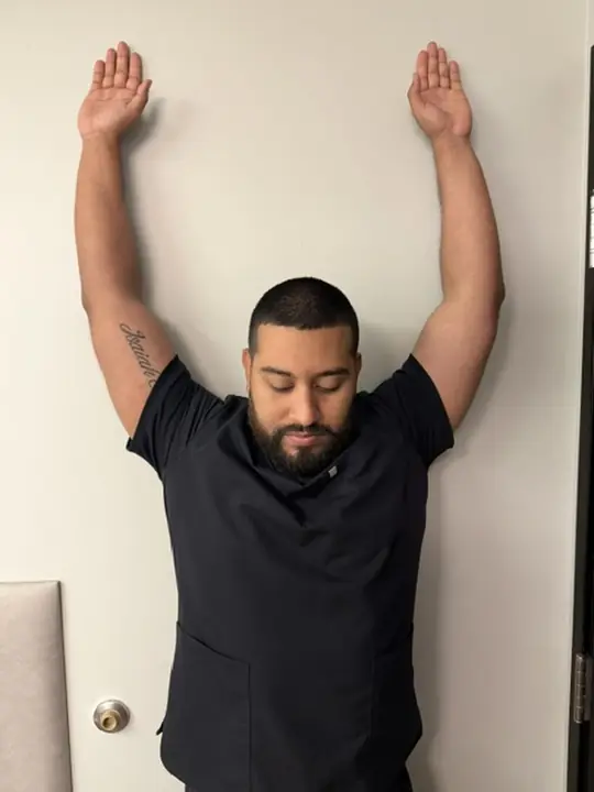 Wall Slides and Wall Angels: End: arms slid up overhead